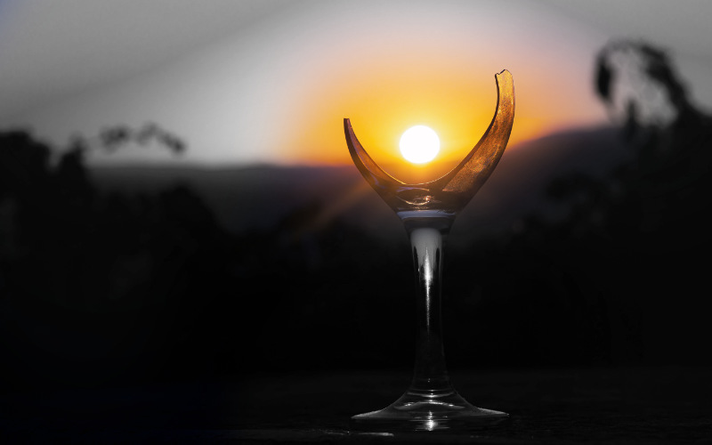 sun shining over broken bottle