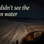 snowmobile on frozen lake heading for open water
