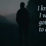 man standing alone on dark road.